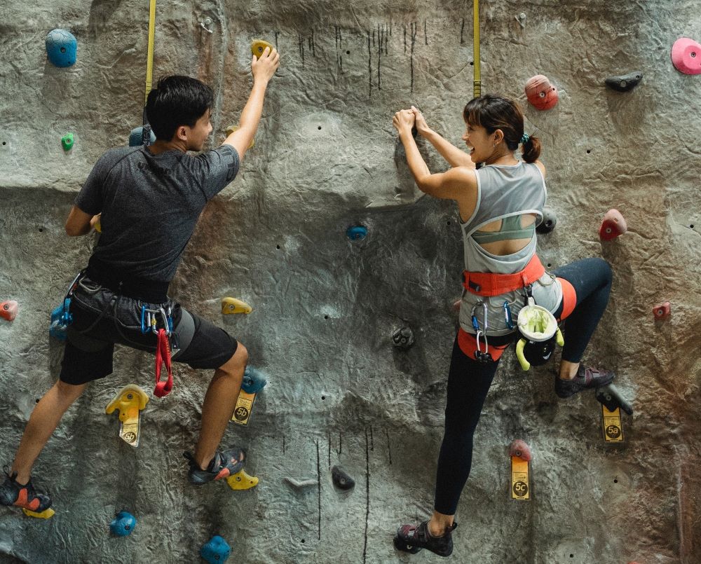 agile couple on climbing wall - trends shaping the future of work