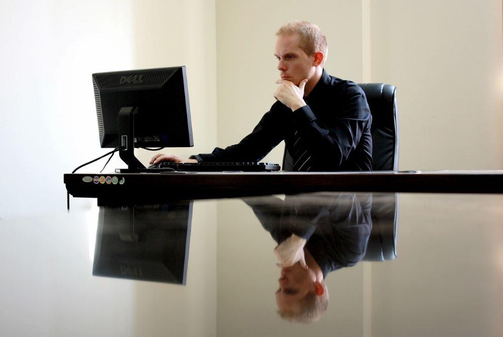 emotional marketing triggers at work with a man staring intently at his computer screen