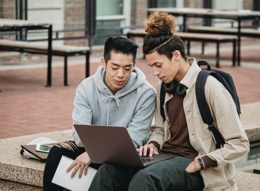 two college students reading about digital badge benefits